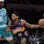 
              Phoenix Suns guard Cameron Payne drives to the basket past Charlotte Hornets forward Jalen McDaniels during the first half of an NBA basketball game on Sunday, Jan. 2, 2022, in Charlotte, N.C. (AP Photo/Chris Carlson)
            