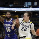 
              Marquette's Tyler Kolek (22) drives to the basket against Seton Hall's Jamir Harris (15) during the first half of an NCAA college basketball game, Saturday, Jan. 15, 2022, in Milwaukee. (AP Photo/Aaron Gash)
            