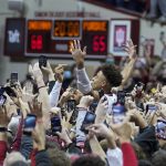 
              Indiana's Rob Phinisee, center right, celebrates with fans after the team defeated Purdue in an NCAA college basketball game, Thursday, Jan. 20, 2022, in Bloomington, Ind. (AP Photo/Darron Cummings)
            