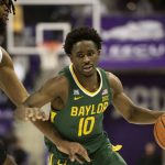 
              Baylor guard Adam Flagler (10) drives past TCU center Eddie Lampkin Jr. (4) to the basket in the first half of an NCAA college basketball game in Fort Worth, Texas, Saturday, Jan. 8, 2022. (AP Photo/Emil Lippe)
            