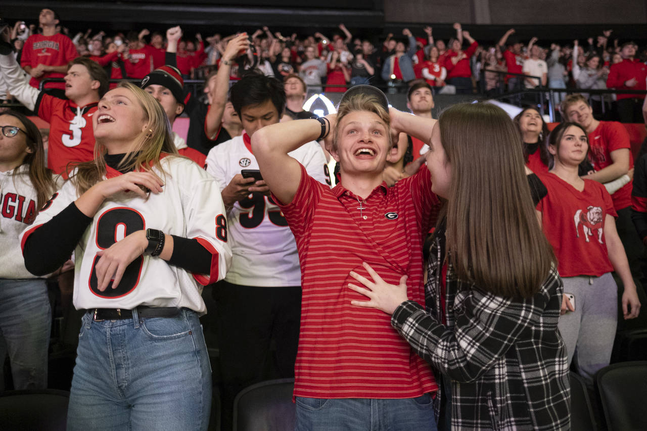 Fans celebrate at the University of Georgia's coliseum in Athens, Ga., as Georgia wins the College ...