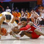 
              Tennessee guard Zakai Zeigler, left, gets his hands on the ball as Mississippi forward Luis Rodriguez (15) reaches for it during an NCAA college basketball game Wednesday, Jan. 5, 2022, in Knoxville, Tenn. Tennessee won 66-60 in overtime. (AP Photo/Wade Payne)
            