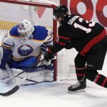 
              Ottawa Senators left wing Zach Sanford tries to put the puck past Buffalo Sabres goaltender Michael Houser during the second period of an NHL hockey game, Tuesday, Jan. 18, 2022 in Ottawa, Ontario. (Adrian Wyld/The Canadian Press via AP)
            