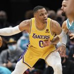 
              Los Angeles Lakers guard Russell Westbrook (0) is guarded by Charlotte Hornets forward Cody Martin (11) during the first half of an NBA basketball game in Charlotte, N.C., Friday, Jan. 28, 2022. (AP Photo/Jacob Kupferman)
            