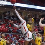 
              Texas Tech's Taylah Thomas (24) lays up the ball around Baylor's Queen Egbo (4) during the first half of an NCAA college basketball game on Wednesday, Jan. 26, 2022, in Lubbock, Texas. (AP Photo/Brad Tollefson)
            