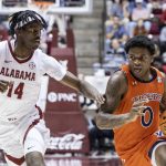 
              Auburn guard K.D. Johnson (0) works around Alabama guard Keon Ellis (14) during the first half of an NCAA college basketball game, Tuesday, Jan. 11, 2022, in Tuscaloosa, Ala. (AP Photo/Vasha Hunt)
            