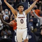 
              Virginia guard Kihei Clark (0) reacts to a three pointer during the second half of an NCAA college basketball game against Louisville Monday Jan. 24, 2022, in Charlottesville, Va. Virginia defeated Louisville 64-52. (AP Photo/Steve Helber)
            