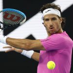 
              Feliciano Lopez of Spain plays a backhand return to John Millman of Australia during their first round match at the Australian Open tennis championships in Melbourne, Australia, Monday, Jan. 17, 2022. (AP Photo/Hamish Blair)
            