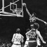 
              FILE - Sixers' Julius Erving (6) dunks the ball through the basket over Chicago Bulls' Artis Gilmore (24) during first half of game in Philadelphia, Pa., Jan. 3, 1979. (AP Photo, File)
            