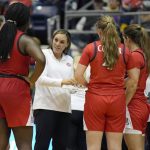 
              FILE - Arizona head coach Adia Barnes speaks to her team during a time out in the first half of an NCAA college basketball game against Northern Arizona, on Dec. 17, 2021, in Flagstaff, Ariz. Barnes' feathery touch has reconstructed her alma mater from the rubble at the bottom of the Pac-12 to a national powerhouse.  (AP Photo/Rick Scuteri)
            