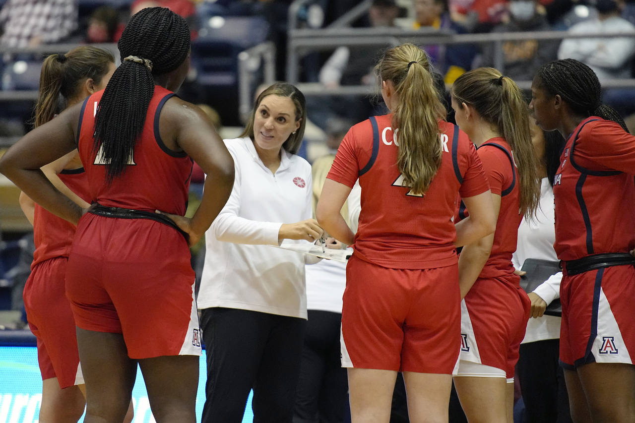 FILE - Arizona head coach Adia Barnes speaks to her team during a time out in the first half of an ...