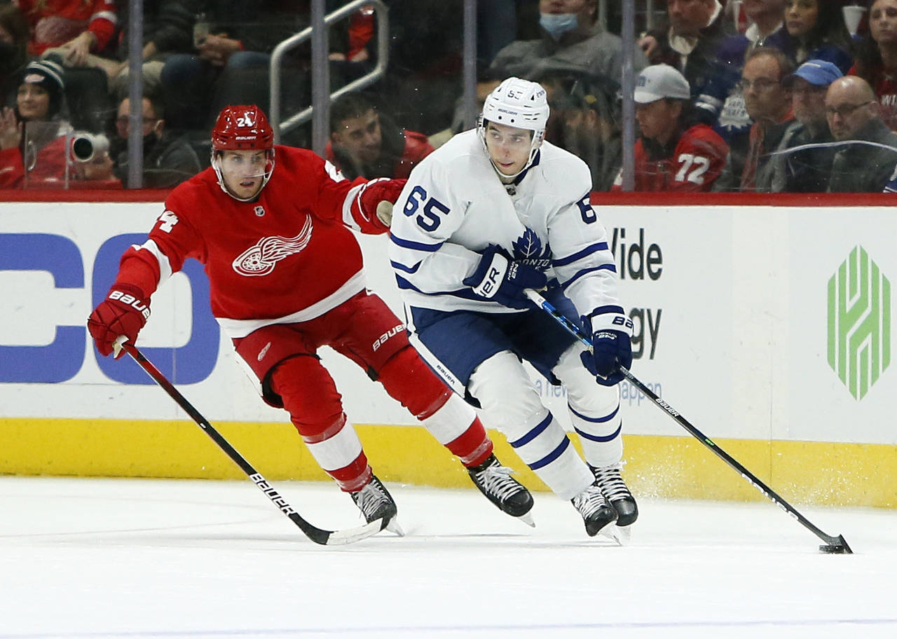 Detroit Red Wings center Pius Suter (24) pursues Toronto Maple Leafs right wing Ilya Mikheyev (65) ...