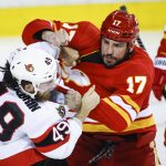 
              Ottawa Senators' Scott Sabourin, left, fights with Calgary Flames' Milan Lucic during second-period NHL hockey game action in Calgary, Alberta, Thursday, Jan. 13, 2022. (Jeff McIntosh/The Canadian Press via AP)
            