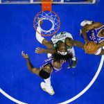 
              Boston Celtics' Robert Williams III, center, goes up for the rebound against Philadelphia 76ers' Tyrese Maxey, right, and Joel Embiid, left, during the first half of an NBA basketball game, Friday, Jan. 14, 2022, in Philadelphia. (AP Photo/Chris Szagola)
            