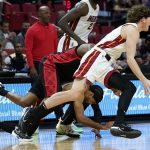 
              Miami Heat guard Kyle Guy, right, drives to the basket during the first half of an NBA basketball game against the Portland Trail Blazers, Wednesday, Jan. 19, 2022, in Miami. (AP Photo/Lynne Sladky)
            