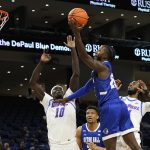 
              Seton Hall's Myles Cale (22) shoots over DePaul's Yor Anei during the first half of an NCAA college basketball game Thursday, Jan. 13, 2022, in Chicago. (AP Photo/Charles Rex Arbogast)
            