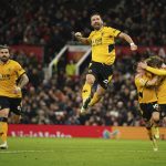 
              Wolverhampton Wanderers' Joao Moutinho celebrates after scoring his side's first goal during the English Premier League soccer match between Manchester United and Wolverhampton Wanderers at Old Trafford stadium in Manchester, England, Monday, Jan.3, 2022. (AP Photo/Dave Thompson)
            