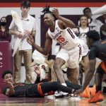 
              Virginia Tech's Justyn Mutts (25) loses the ball after colliding with Miami defender Miami's Jordan Miller (11) left, during the first half of an NCAA college basketball game, Wednesday, Jan. 26 2022, in Blacksburg Va. (Matt Gentry/The Roanoke Times via AP)
            