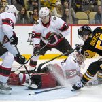 
              Pittsburgh Penguins' Jake Guentzel (59) goes after a rebound between the legs of Ottawa Senators goalie Filip Gustavsson (32) with Nick Holden (5) and Adam Gaudette (17) defending during the second period of an NHL hockey game in Pittsburgh, Thursday, Jan. 20, 2022. (AP Photo/Gene J. Puskar)
            
