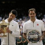 
              FILE - Serbia's Novak Djokovic and Switzerland's Roger Federer pose with the trophies after the men's singles final match of the Wimbledon Tennis Championships in London, July 14, 2019. After saving two match points to beat Federer in a five-set thriller in the 2019 Wimbledon final, Djokovic explained how he coped during what was “probably the most mentally demanding match” of his career, playing against arguably the most-loved tennis player of all time. (AP Photo/Tim Ireland, File)
            