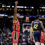 
              New Orleans Pelicans guard Devonte' Graham (4) reacts after scoring a three-point basket against Indiana Pacers forward Oshae Brissett (12) in the fourth quarter of an NBA basketball game in New Orleans, Monday, Jan. 24, 2022. (AP Photo/Derick Hingle)
            