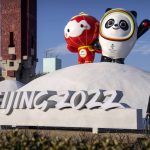 
              A worker wearing a face mask to help protect against the coronavirus walks past a display of the Winter Paralympic mascot Shuey Rhon Rhon, left, and Winter Olympic mascot Bing Dwen Dwen near the Olympic Green in Beijing, Wednesday, Jan. 12, 2022. Just weeks before hosting the Beijing Winter Olympics, China is battling multiple coronavirus outbreaks in half a dozen cities, with the one closest to the capital driven by the highly transmissible omicron variant. (AP Photo/Mark Schiefelbein)
            