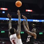 
              North Carolina State forward Ernest Ross (24) shoots over Louisville forward Malik Williams (5) during the first half of an NCAA college basketball game in Louisville, Ky., Wednesday, Jan. 12, 2022. (AP Photo/Timothy D. Easley)
            