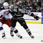 
              New Jersey Devils center Michael McLeod (20) holds off Columbus Blue Jackets left wing Eric Robinson (50) during the first period of an NHL hockey game Thursday, Jan. 6, 2022, in Newark, N.J. (AP Photo/Bill Kostroun)
            