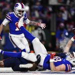 
              Buffalo Bills tight end Dawson Knox (88) scores a touchdown against New England Patriots safety Adrian Phillips, below, during the first half of an NFL wild-card playoff football game, Saturday, Jan. 15, 2022, in Orchard Park, N.Y. (AP Photo/Adrian Kraus)
            