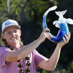 
              Cameron Smith holds the champions trophy after the final round of the Tournament of Champions golf event, Sunday, Jan. 9, 2022, at Kapalua Plantation Course in Kapalua, Hawaii. (AP Photo/Matt York)
            