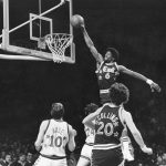 
              FILE - Sixers' Julius Erving (6) dunks the ball through the basket over Chicago Bulls' Artis Gilmore (24) during first half of game in Philadelphia, Pa., night, Jan. 3, 1979. (AP Photo, File)
            