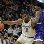 
              Marquette's Justin Lewis (10) drives to the basket against Seton Hall's Tyrese Samuel during the first half of an NCAA college basketball game, Saturday, Jan. 15, 2022, in Milwaukee. (AP Photo/Aaron Gash)
            