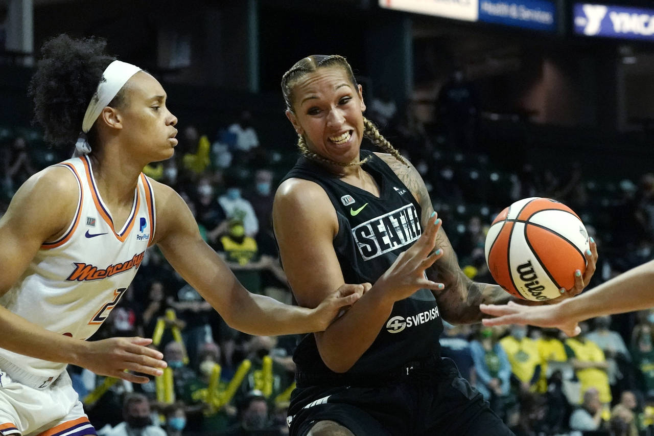 FILE - Seattle Storm's Mercedes Russell, right, drives against Phoenix Mercury's Megan Walker in th...