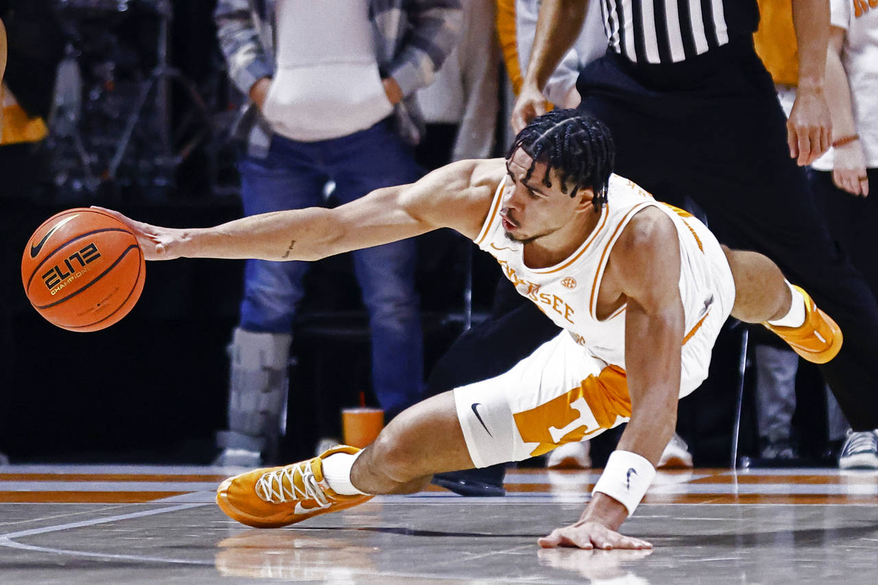 Tennessee forward Olivier Nkamhoua (13) dives for a loose ball during an NCAA college basketball ga...