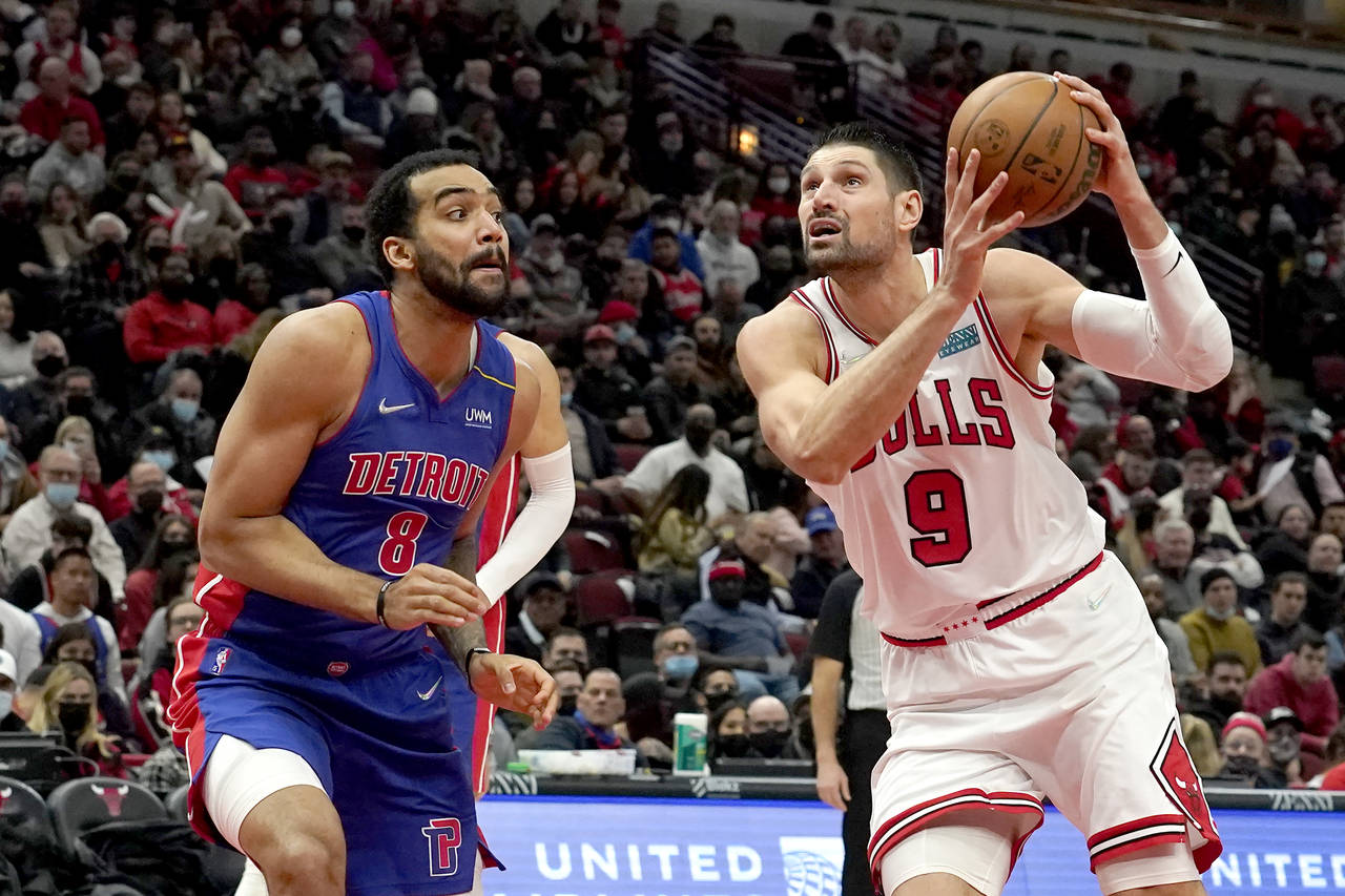 Chicago Bulls' Nikola Vucevic (9) drives to the basket past Detroit Pistons' Trey Lyles during the ...