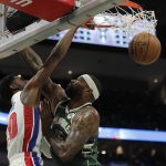 
              Detroit Pistons' Josh Jackson, left, dunks over Milwaukee Bucks' DeMarcus Cousins during the first half of an NBA basketball game Monday, Jan. 3, 2022, in Milwaukee. (AP Photo/Aaron Gash)
            