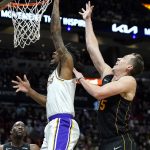 
              Los Angeles Lakers guard Malik Monk, front left, goes to the basket as Miami Heat guard Duncan Robinson, right, defends during the first half of an NBA basketball game, Sunday, Jan. 23, 2022, in Miami. (AP Photo/Lynne Sladky)
            