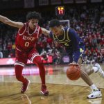 
              Rutgers guard Geo Baker (0) defends as Michigan guard Kobe Bufkin (2) moves the ball during the first half of an NCAA college basketball game Tuesday, Jan. 4, 2022, in Piscataway, N.J. (Andrew Mills/NJ Advance Media via AP)
            