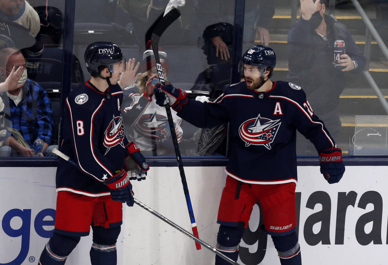 Columbus Blue Jackets forward Oliver Bjorkstrand, right, celebrates his goal against the New Jersey...