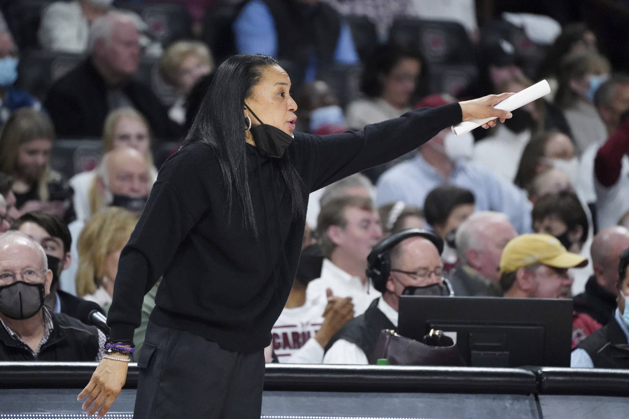 South Carolina head coach Dawn Staley communicates with players during the second half of an NCAA c...