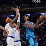 
              Charlotte Hornets guard Ish Smith (10) shoots past New York Knicks guard Immanuel Quickley (5) during the first half of an NBA basketball game, Monday, Jan. 17, 2022, in New York. (AP Photo/John Minchillo)
            