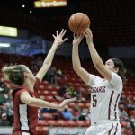 
              Washington State guard Charlisse Leger-Walker, right, shoots over Stanford guard Lexie Hull during the first half of an NCAA college basketball game, Sunday, Jan. 2, 2022, in Pullman, Wash. (AP Photo/Young Kwak)
            