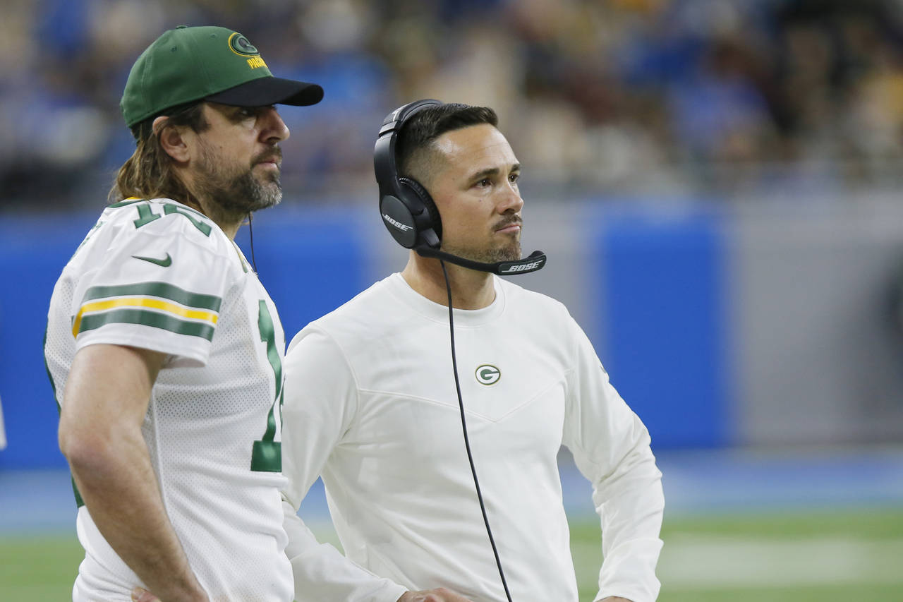 Green Bay Packers quarterback Aaron Rodgers and head coach Matt LaFleur watch from the sideline dur...