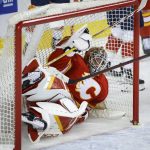 
              Calgary Flames goalie Jacob Markstrom looks out from the net after letting in a goal to the Florida Panthers during the second period of an NHL hockey game Tuesday, Jan. 18, 2022, in Calgary, Alberta. (Jeff McIntosh/The Canadian Press via AP)
            