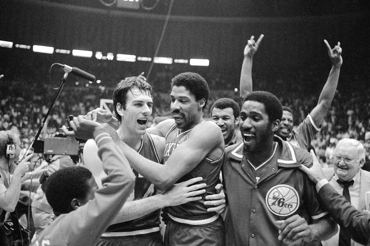 FILE - Philadelphia 76ers Bobby Jones, left, embraces Julius Erving after the 76ers defeated the Lo...