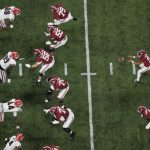 
              Alabama's Bryce Young takes a snap during the first half of the College Football Playoff championship football game against Georgia Monday, Jan. 10, 2022, in Indianapolis. (AP Photo/Charlie Riedel)
            