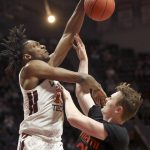 
              Miami's Sam Waardenburg (21) has his shot blocked and is fouled by Virginia Tech's Justyn Mutts (25) during the first half of an NCAA college basketball game, Wednesday, Jan. 26 2022, in Blacksburg Va. (Matt Gentry/The Roanoke Times via AP)
            