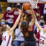 
              Indiana guard Grace Berger (34), left, and forward Mackenzie Holmes (54) attempt to block a shot by Maryland forward Angel Reese (10) during the second half of an NCAA college basketball game, Sunday, Jan. 2, 2022, in Bloomington, Ind. (AP Photo/Doug McSchooler)
            