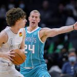 
              Charlotte Hornets center Mason Plumlee (24) defends against Oklahoma City Thunder guard Josh Giddey during the first half of an NBA basketball game Friday, Jan. 21, 2022, in Charlotte, N.C. (AP Photo/Rusty Jones)
            
