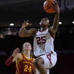 
              Oklahoma guard Madi Williams (25) goes to the basket in front of Iowa State guard Ashley Joens (24) during the second half of an NCAA college basketball game Wednesday, Jan. 5, 2022, in Norman, Okla. (AP Photo/Sue Ogrocki)
            